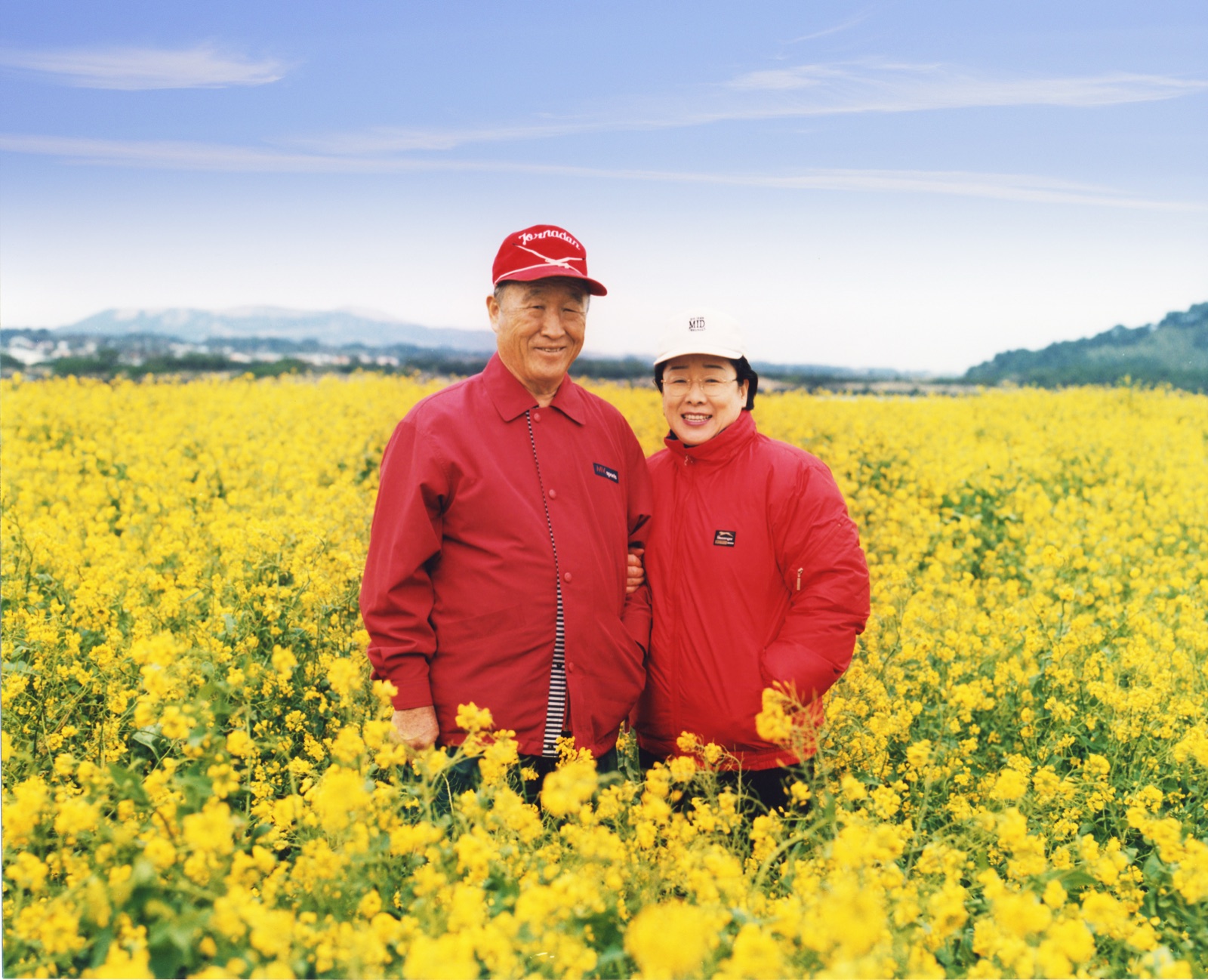 True Father and True Mother in a field of yellow flowers